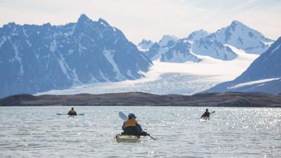 Passengers kayaking in Arctic Landscape