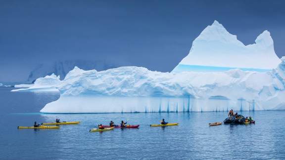 Passengers Kayaking near icy landscape